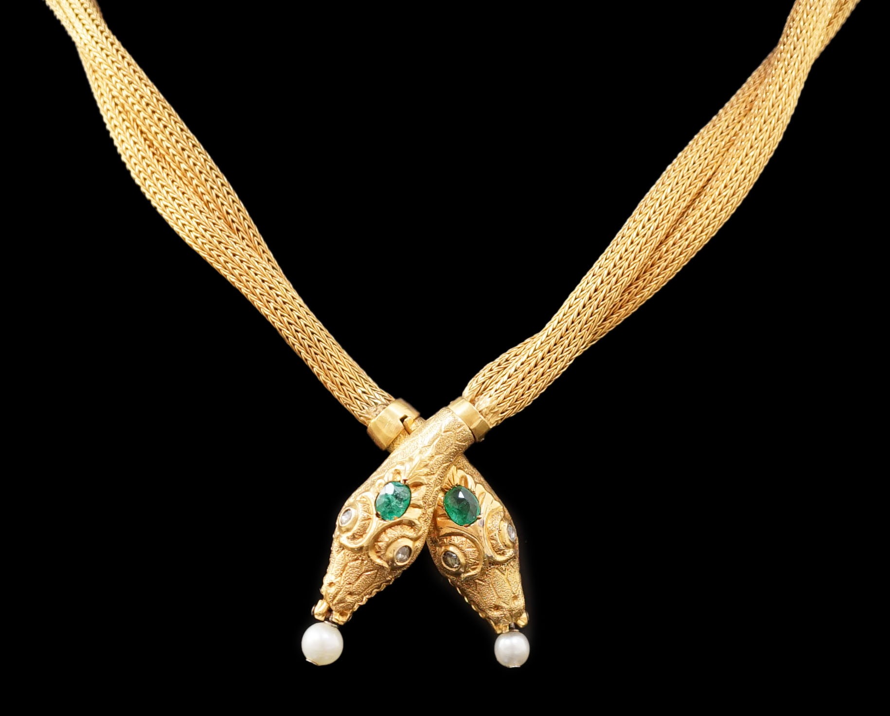 An early 20th century multi-strand gold, emerald, rose cut diamond and cultured pearl drop set twin headed serpent necklace